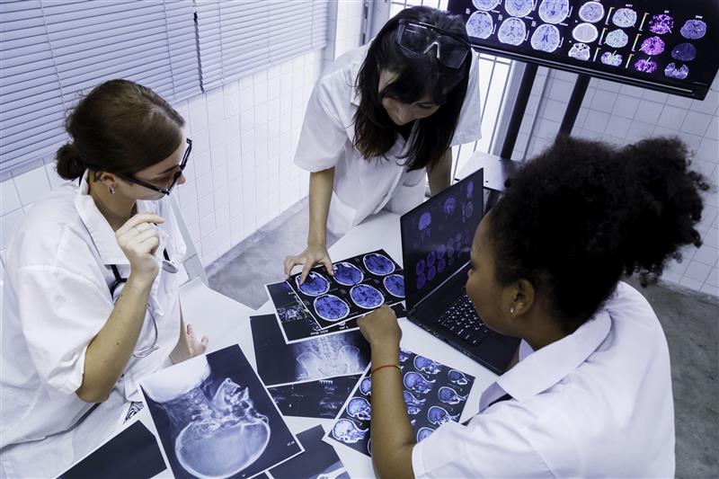 Doctor and student interns looking at medical images