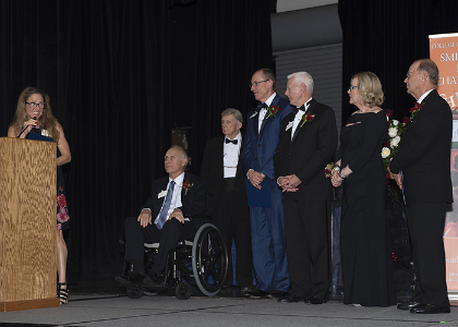 Happy speaker looks at award recipients