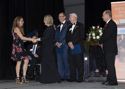 Speaker shakes Vaughan's hand on stage