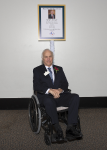 Barnard posing in front of award