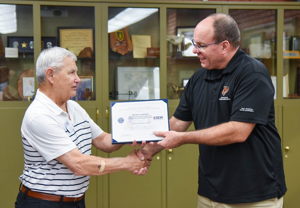 George Nami, an ESGR representative, shakes hands with Mike Aspland.