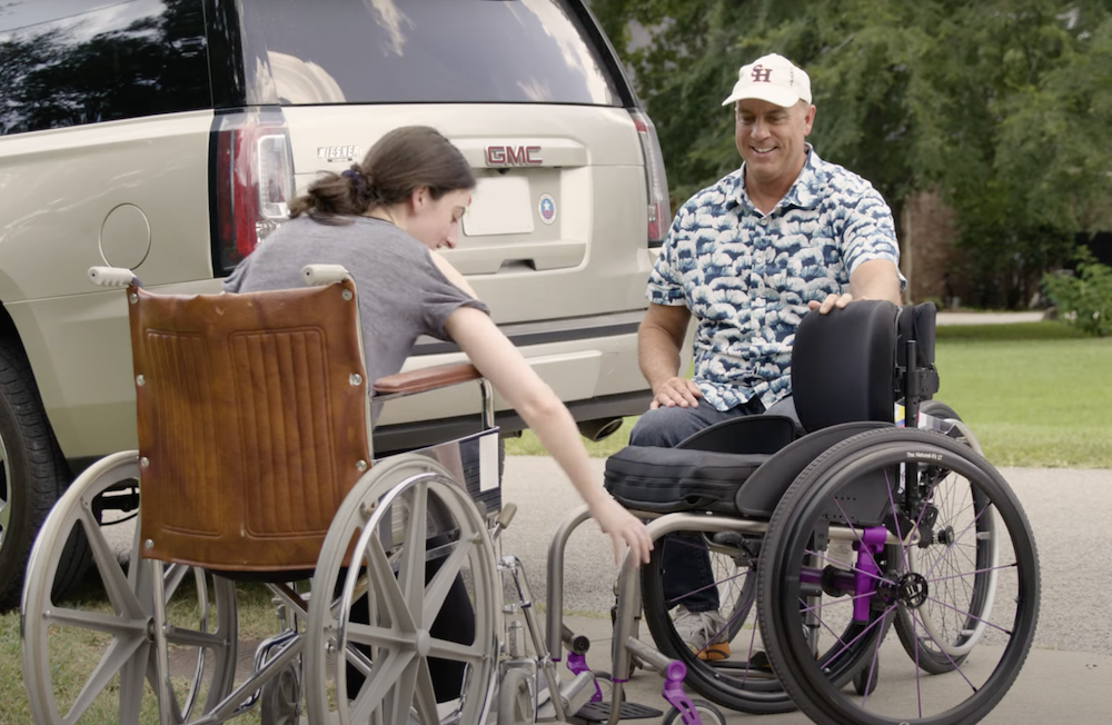 Rachel Stewart receives a new wheelchair from her professor, Col. Rob Harmon.