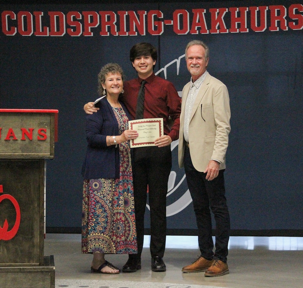 Paula McGraw Franklin (left) and Bill McGraw (right) present Luc Butler (center) with the Dusty Ann McGraw Clark Memorial Scholarship.