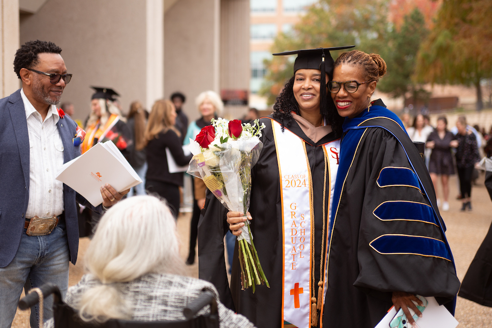 Theresa Johnson (second from right) with her family and Associate Professor Carla Jones (right).