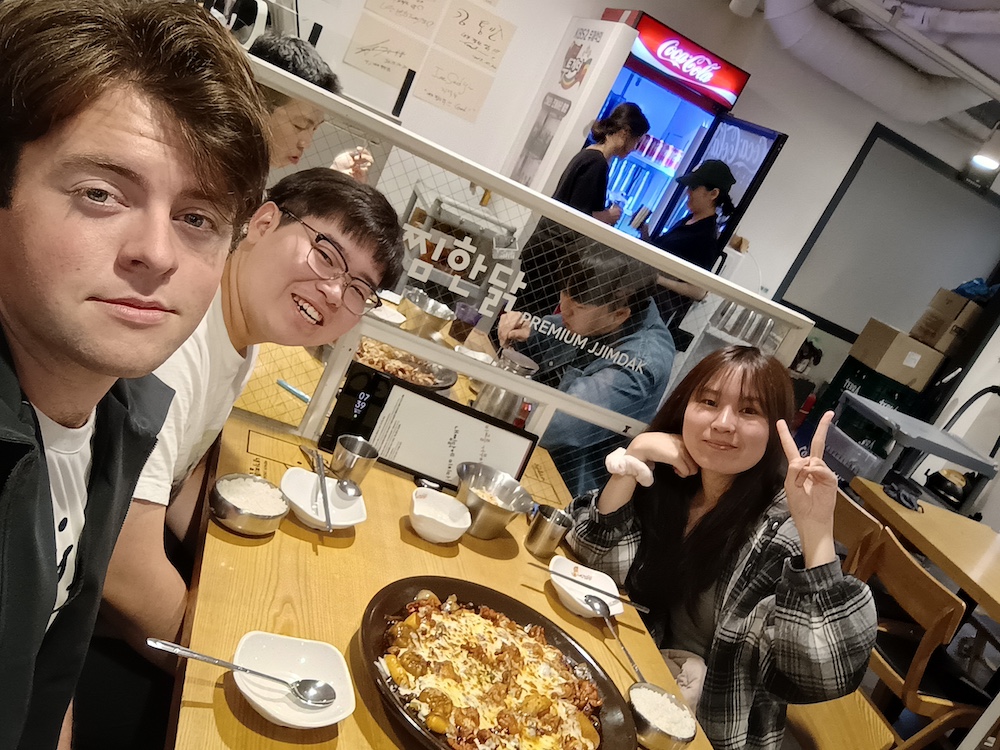 Noah Ewald (left) at a restaurant with friends in South Korea.