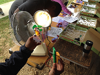 Students building solar and wind circuits during an Earth Day Festival