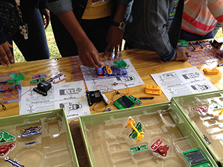 Students building solar and wind circuits during an Earth Day Festival